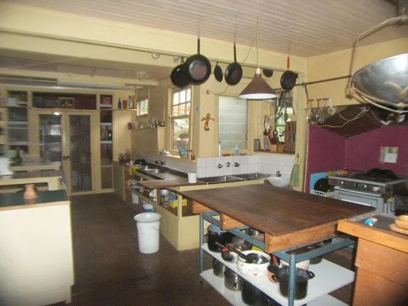 The old kitchen with pots hanging over a timber bench