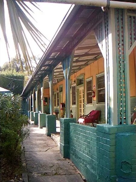 The long verandah with its lattice and painted brick piers