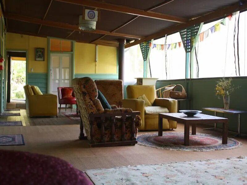 The sunroom with armchairs and rugs