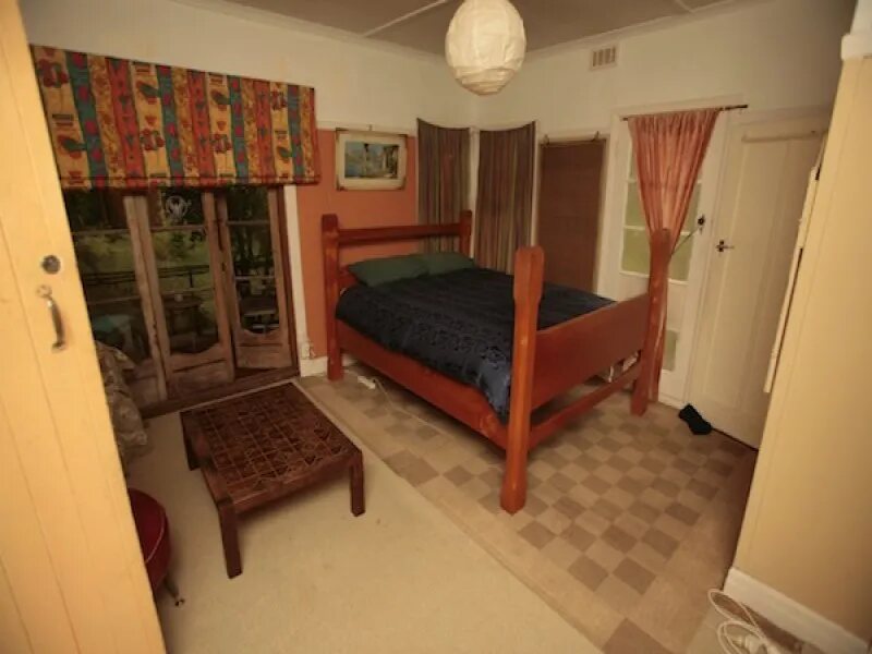 A timber bunk bed and coloured curtains