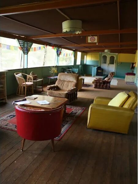 Armchairs and a red tub chair in the sunroom